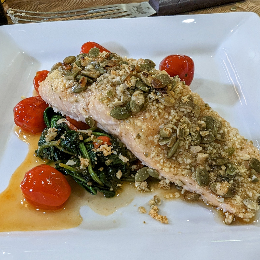Parmesan and Pumpkin Seed Crusted salmon served with Wilted Spinach and Tomatoes recipe